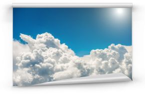 Fototapeta Białe chmury, czyste niebo, jasne słońce optycznie powiększająca