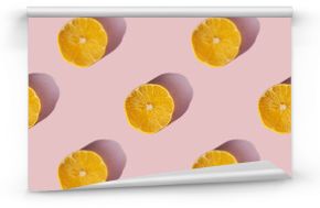 Uniform pattern of dried lemon slices with shadow on a pink background. Flat lay