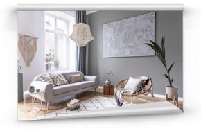 Modern and bohemian composition of interior design with gray sofa, rattan armchair, wooden cube, plaid, pillow, tropical plants, small table and elegant accessories. Stylish home decor. Template.