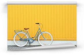 Retro bicycle near yellow wall outdoors