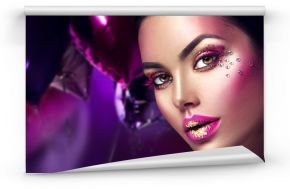 Beauty fashion model girl creative art makeup with gems. Woman face over purple, pink and violet air balloons background