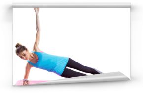 Fit woman using mobile while doing side plank