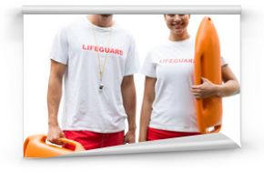 Portrait of lifeguards holding rescue buoy