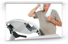 Tired senior man running on a treadmill