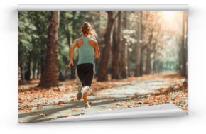 Woman Jogging Outdoors in The Fall