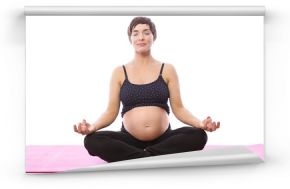 Pregnent woman sitting on mat in lotus pose over white background