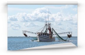 Marine shrimp fishing boat in Gulf of Mexico with nets out to catch seafood