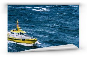 Coast guard boat patrol riding on rough sea waves in Alaska. Panoramic banner background.
