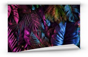 Tropical dark trend jungle in neon illuminated lighting. Exotic palms and plants in retro style.