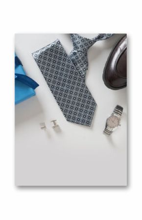 Happy Fathers Day greeting card with gift box. Set of classic mens clothes - brown shoes, wrist watch, necktie and blue gift on gray background. Men's accessories set. Top view. Copy space.