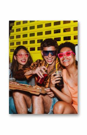 Friends going out in the evening and making party. Young people meeting outdoor in the weekend and celebrating together.