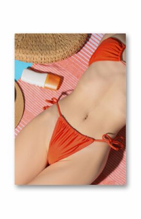 Young woman in swimsuit with beach accessories lying on blue background, top view