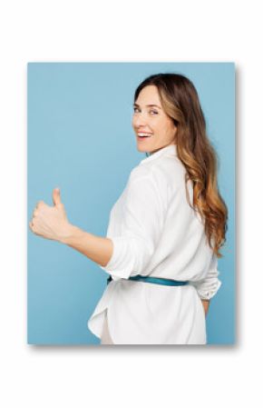 Sideways young employee business woman corporate lawyer she wear shirt classic formal clothes work in office show thumb up like gesture isolated on pastel light blue color background studio portrait.