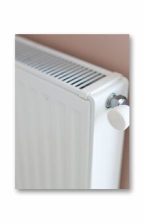 White home radiator with control valve on pink wall for efficient heating