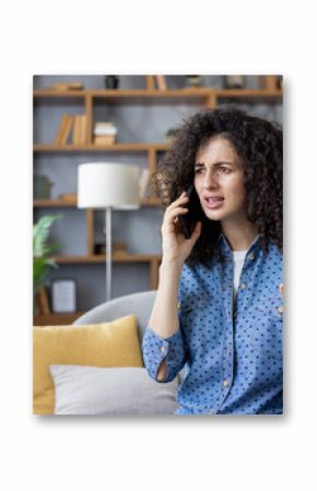 Frustrated woman arguing on phone at home