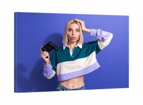 Young stylish woman holding a gaming controller with a surprised expression in a casual colorful outfit