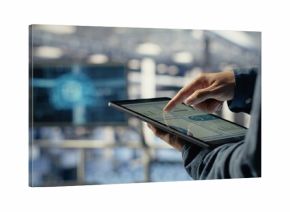 Server room employee checks data charts on tablet to monitor system health. System administrator reviews graphs to make sure data center meets business goals and client needs, camera B