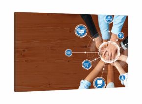A dynamic overhead view showcasing diverse hands reaching towards digital icons, symbolizing collaboration and teamwork in a modern business environment. Amity