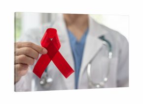 World aids day and national HIV AIDS and ageing awareness month with red ribbon on medical or surgical doctor's hand in hospital background