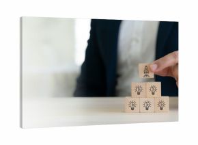 Idea creation and innovative product launching concept. Wooden block  with rocket and idea generation icons. Idea creation, innovation and the launch of a new product from concept to execution.