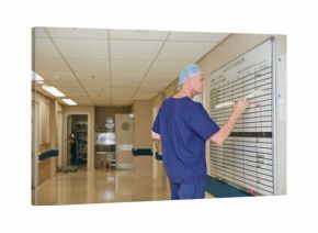 Surgeon, whiteboard and writing in hospital with schedule, operation theater roster or organization. Mature man, doctor and notice board in clinic with healthcare calendar, surgery timetable or plan.