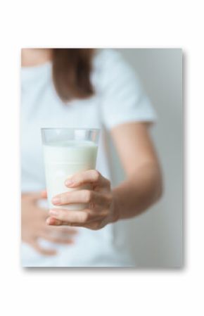 Lactose intolerance and Milk allergy concept. woman hold Milk glass and having abdominal cramps and pain when drink Cow Milk. Symptom stomach ache, Dairy intolerant, Nausea, Bloating, Gas and Diarrhea