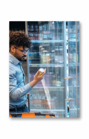 Near fridge with water. Man is in the grocery store