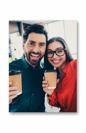 Two colleagues enjoying coffee together in a modern office setting, showcasing teamwork, collaboration