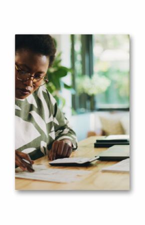 Finance, budgeting and black woman with invoice in home for financial planning, savings or auditing. Wealth, person or laptop with receipt documents for tax return, account review or asset management