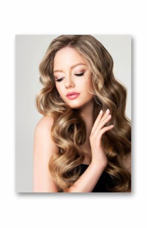 Blonde  girl with long  and   shiny wavy  hair .  Beautiful  model woman with curly hairstyle . Beauty and cosmetology