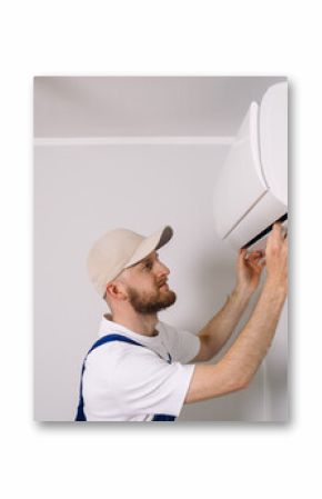 Maintenance technician performs air conditioning installation in a modern apartment