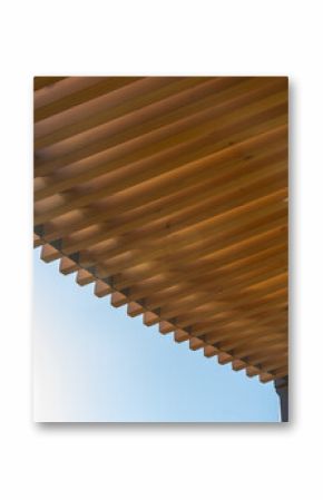 Minimalist sunshade design made of wooden slats for architecture projects. Wooden pergola canopy with beams against blue sky, modern outdoor structure.