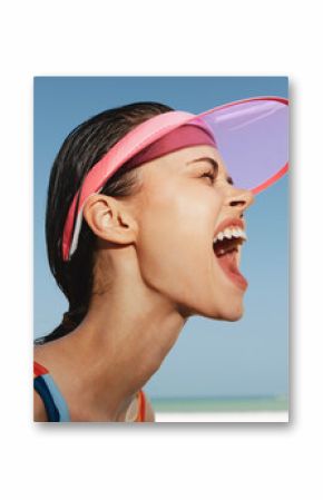 Close up portrait of a joyful woman at the beach, wearing a pink visor, mouth wide open in laughter, sunlit skin, damp hair, and a bright blue sky behind, energetic mood.
