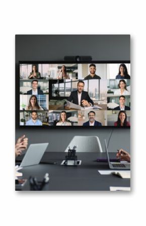 Group of diverse businesspeople gathered in boardroom engaging in videoconference