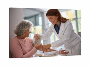 Senior woman getting her blood pressure measured by pharmacist in drugstore.
