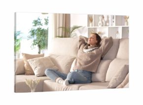 Relaxed woman at home sitting on a comfortable couch in winter