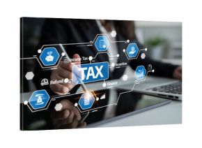 A tax consultant engages with a digital tablet displaying tax graphics and icons, symbolizing modern finance solutions and strategic planning in a professional office. Tessel