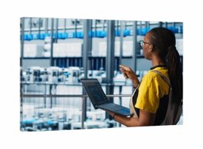 Engineers in industry 4.0 industrial plant controlling automated machinery, ensuring workflow continuity. Technicians in smart factory managing robotic arms and conveyor belts, camera A