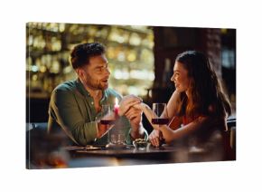 Loving boyfriend talking girlfriend holding hands in luxury night club closeup.