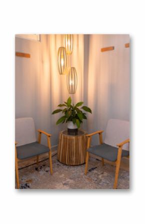 Modern waiting area with stylish chairs, wooden table, and hanging lights