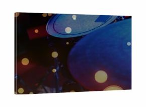 Showcasing drum kit bathing in warm bokeh lights on dim stage, with tom drum, cymbal, stands