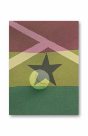 Resting yellow tennis ball at center of striped outdoor tennis court, with white lines, black star