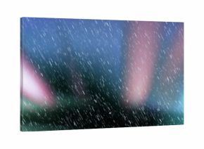 Simulating white rain streaks falling diagonally in digital background, with blurry colored lights