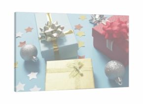 Displaying light-blue red gold wrapped gifts on pale-blue table with silver ornaments star confetti