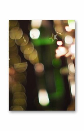 Sparkler glowing with golden star image over blurred festive lights background