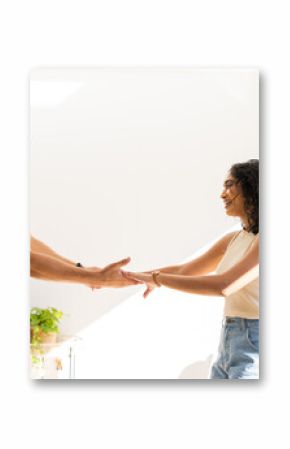 Young couple holding hands and smiling, enjoying quality time together indoors