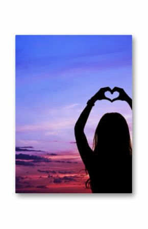 Female silhouette with raised hands in a heart shape against the sky
