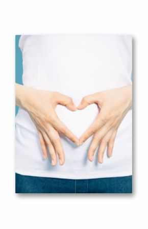 young woman who makes a heart shape by hands on her stomach.