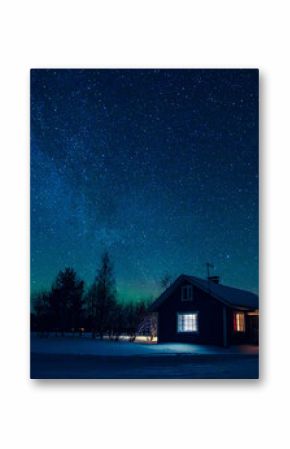 Domek na tle nocnego nieba z Drogą Mleczną i arktyczną zorzą polarną Aurora Borealis w śnieżnej zimie Finlandia