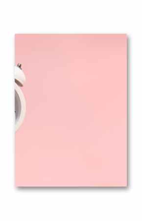 Pink Alarm clock on pastel pink background.
